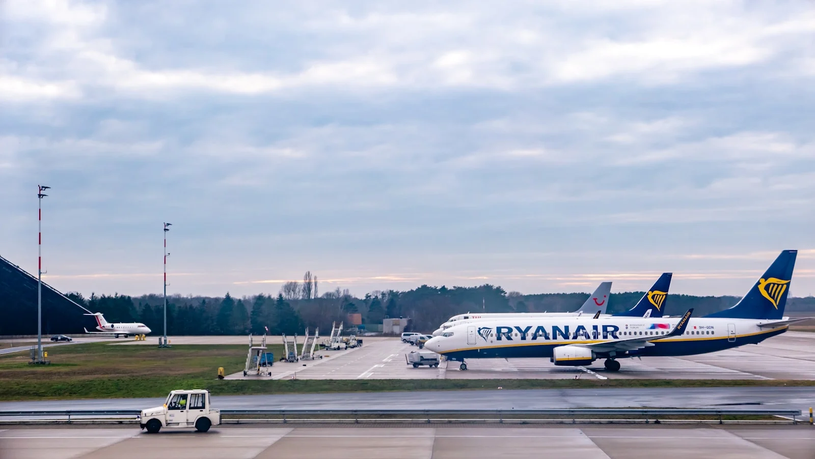 white and red passenger plane on airport during daytime